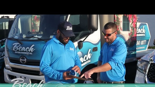 Two men in matching blue polo shirts, with the logo "Beach Environmental",
